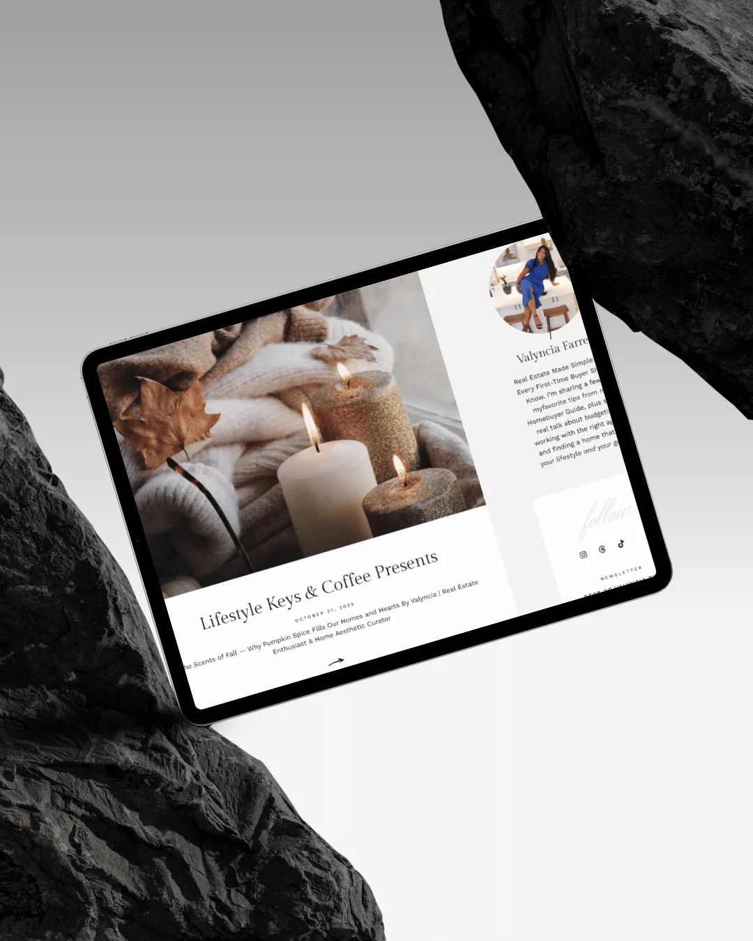 An iPad resting between black rocks, open on the featured article — The Scents of Fall, from the Life Style topic
